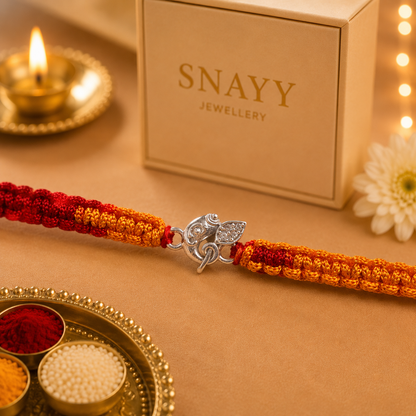 Premium Silver Ganesh Rakhi with CZ Stone & Handwoven Red Yellow Thread