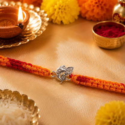 Premium Silver Ganesh Rakhi with CZ Stone & Handwoven Red Yellow Thread