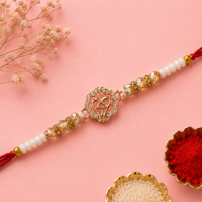 Gold Finish Om Rakhi with Pearl Beads