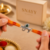 Silver Krishna Flute Rakhi with Green Stone