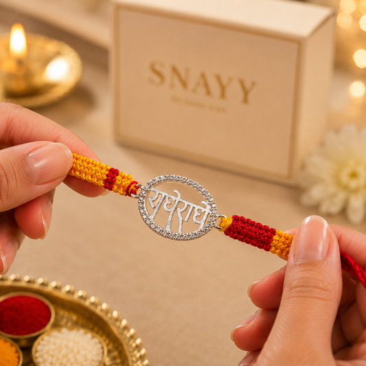 Silver Radhe Radhe Rakhi with Stone Border